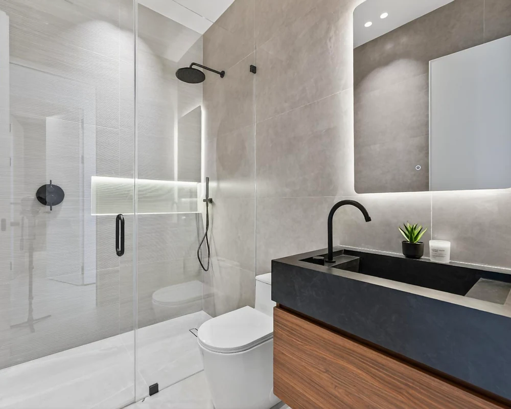 Wood-finish bathroom vanity and black basin in the Miami project