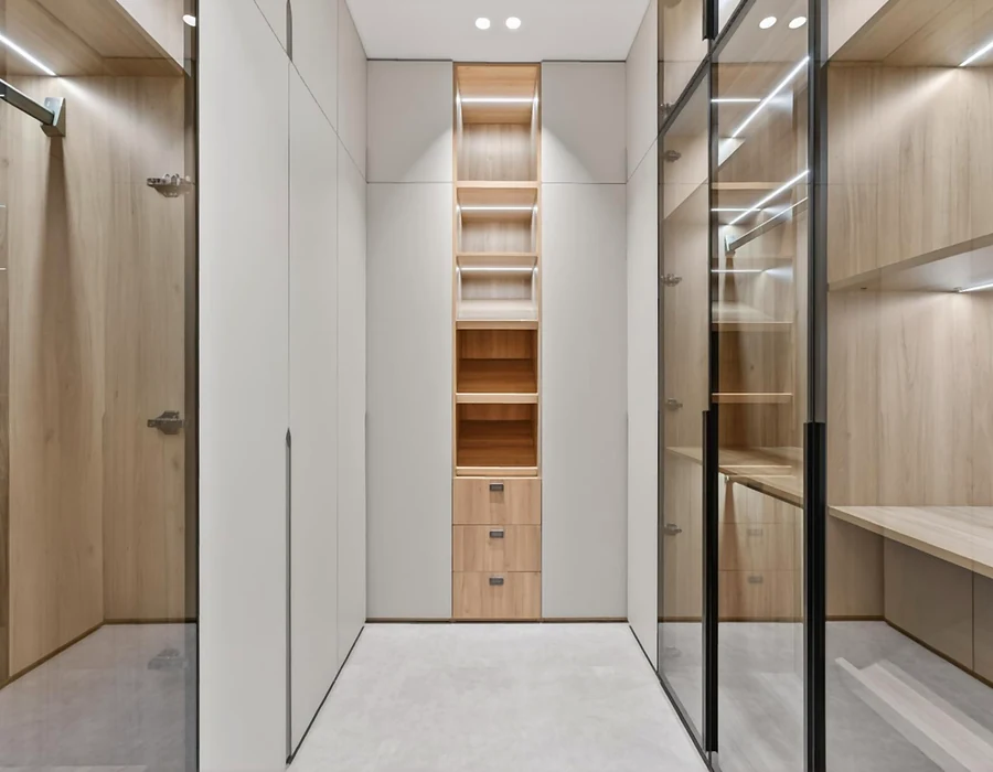 Walk-in wardrobe with glass-front storage in the Miami project