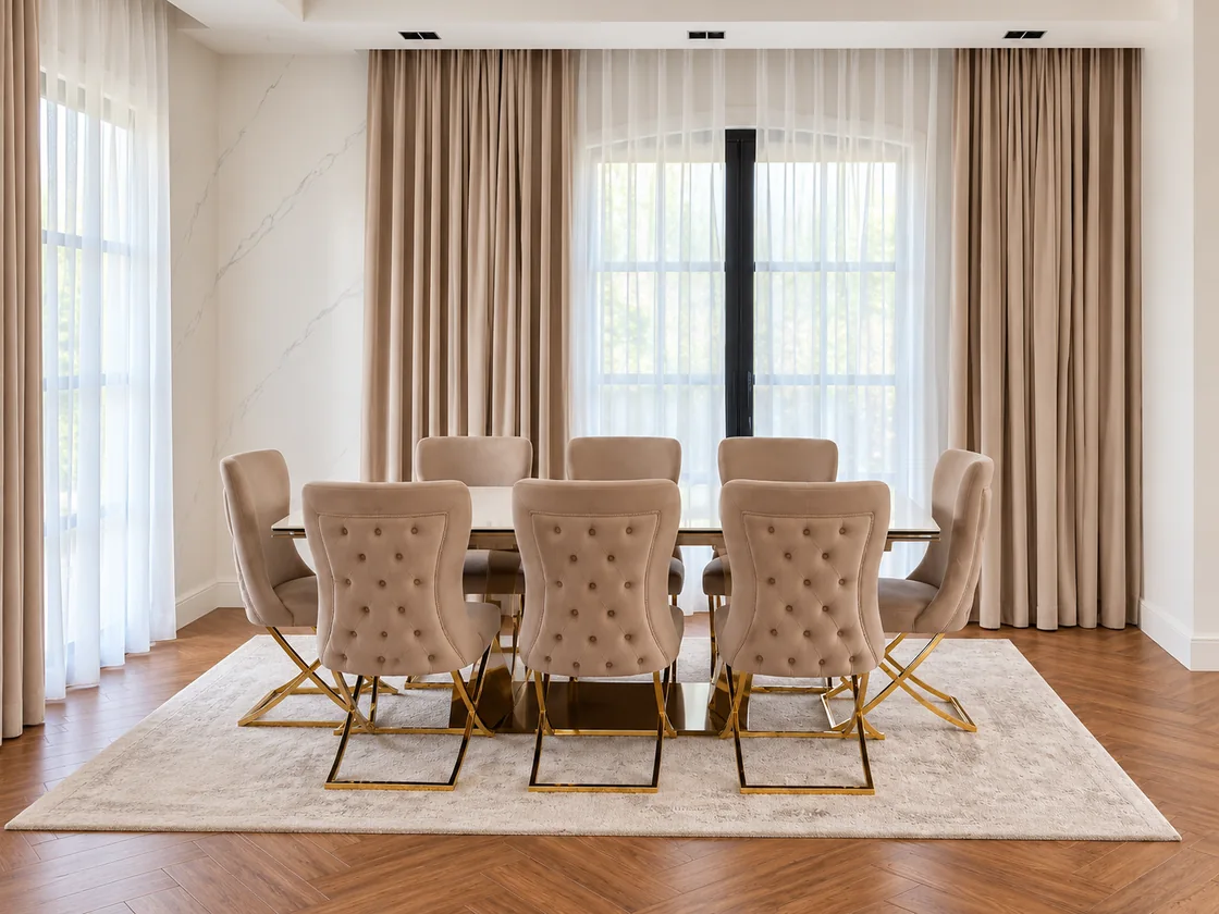 Upholstered dining chairs with gold frames around the villa dining table